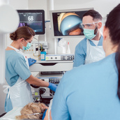 Team of doctors in hospital at endoscopy examining pictures