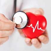 doctor hands holding red heart and stethoscope