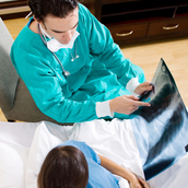 medical surgeon visiting patient in hospital ward